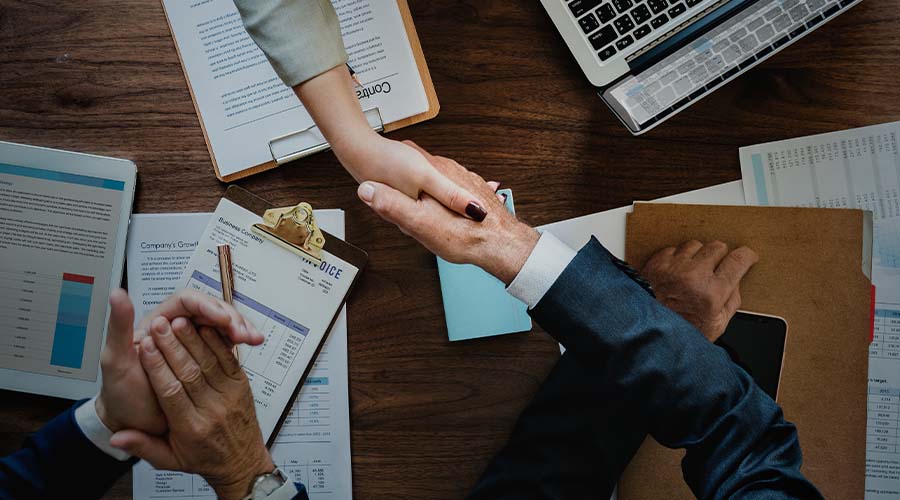 business people shaking hands together